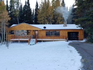 Remodel with log siding and Timberline log corners on ugly house in Wyoming.