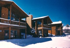 Log sided lodge in the snow in Estes Park