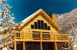 Timberline log siding and log deck in mountains.