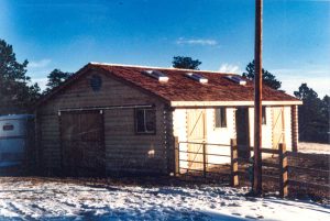 Log horse barn in mountains