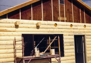 Log rafter tails on log siding