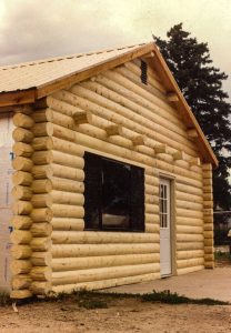 log sided building with rafter tails.
