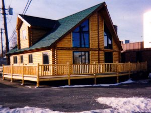 Modular home with log siding and prow front.