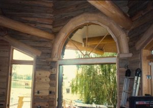 Interior beetle kill wood. arched log trim window