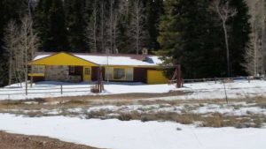 Remodel with log siding and Timberline log corners on ugly house in Wyoming.