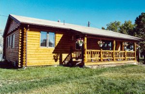 Remodel with log siding and Timberline log corners on house with lap siding. Beautiful log orch