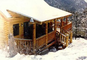 Log home porch in the snow