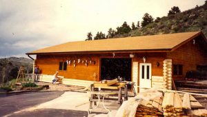 Log garage on side of mountain.